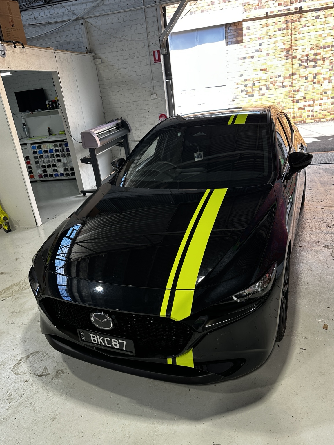 Black Mazda with neon stripe styling